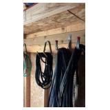 lots of garden hoses and Wall hangers