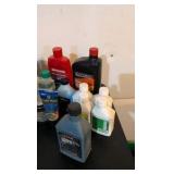 hodgepodge of oil and other random liquids in a green bucket