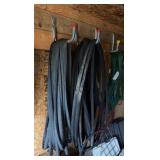 lots of garden hoses and Wall hangers