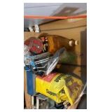 shelf contents including fertilizer, cleaner, nail screws, and tools