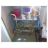 Brass & glass cart with misc figurienes. As shown.CASH ON SITE ONLY. PICKUP IS TUESDAY MAY 19TH FROM 11 AM TO 4 PM. REGARDLESS WHAT THE SCHEDULE STATES.