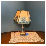 Vintage nautical-themed table lamp with doily