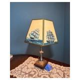 Vintage nautical-themed table lamp with doily