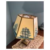 Vintage nautical-themed table lamp with doily