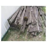 Large pile of weathered wood planks...