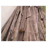 Large pile of weathered wood planks...