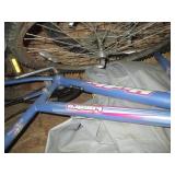 Contents of a shelf including tires, Huffy bike and more!