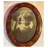 Vintage cupid awake lithograph by M. V. Parkinson in oval frame