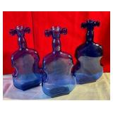 Collectable group of cello shaped cobalt blue glass bottles