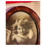 Vintage cupid awake lithograph by M. V. Parkinson in oval frame