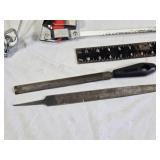 Assorted Tools and Accessories including Husky Hacksaw, Files, Speed Square, Extension Cords, and Power Strip