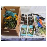 Box of Home and Garden Decor Items Including Decorative Flags, Artificial Flowers, Fabric, and Garden Tools