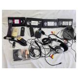 Various Electronics and Accessories Including VHS Tapes, Remotes, and Headphones