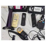 Various Electronics and Accessories Including VHS Tapes, Remotes, and Headphones