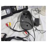 Various Electronics and Accessories Including VHS Tapes, Remotes, and Headphones