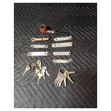 Vintage bottle openers, whistle, keys and a pipe