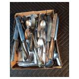 Large box of assorted silverware with set of tin measuring spoons
