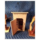 Wooden man. outhouse, and lady
