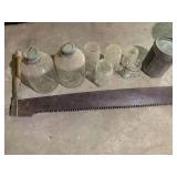 Vintage glass jars, saw and metal o...