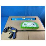 Empire True Blue level, a Milwaukee hole saw kit, and an Irwin Quick-Grip clamp.