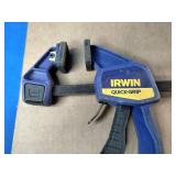 Empire True Blue level, a Milwaukee hole saw kit, and an Irwin Quick-Grip clamp.