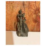 vintage pewter or bronze statue of a woman riding a bicycle