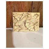 Bunny wall plaque crafted from stone.