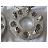 Wheel spacers including One @ 5x114.3-5x120.65 and Three @ 5-4.75/5-4.75 patterns, aluminum construction with bolt-on design.