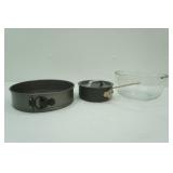 spring form cheesecake pan, glass mixing bowl, small pot with lid
