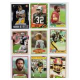 Lot Of 9 Football Cards Including 1989 Topps Michael Irvin #383 Rookie Card, 1980 Topps #225 Phill Simms Rookie Card, and More!