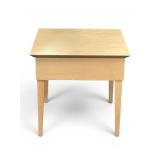 light wood accent table with tapered legs and a minimalist design