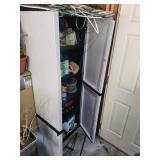 Tall Storage Cabinet With Assorted Garden Supplies