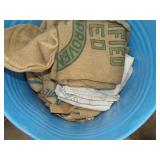 Metal Barrel with Canvas and Feed Sacks with Markings