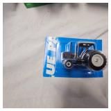 Lot of Die Cast Tractors in Packages as shown