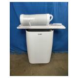 Airo Comfort portable air conditioner featuring a white finish and an included window vent kit