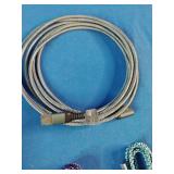 Ten assorted electronic data and charging cables organized against a solid blue background.