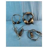 Two distinct wired headsets resting on a blue textured fabric background.
