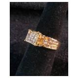 Yellow gold colored multi-row cluster ring featuring a distinctive square or grid-patterned center head. Size 7.25