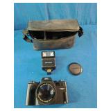 This is a Benz-Gant Helioflex 3000T 35mm film camera, which features a 50mm lens and is often sold as a kit with a detachable flash and carrying case