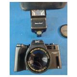 This is a Benz-Gant Helioflex 3000T 35mm film camera, which features a 50mm lens and is often sold as a kit with a detachable flash and carrying case
