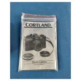 Brand New Vintage 1980's Cortland CX-7 35mm film camera, packaged with its original manual and black carrying case.