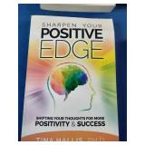 Collection of six self-improvement, financial literacy, leadership, and communication books laid out on a blue fabric surface.