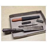 Old woodworking and sharpening tools including large Wooden chisel, sharpening stones, and honing tools