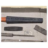 Old woodworking and sharpening tools including large Wooden chisel, sharpening stones, and honing tools