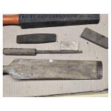 Old woodworking and sharpening tools including large Wooden chisel, sharpening stones, and honing tools