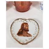 Assorted Glass and Ceramic Home Decor Items including Red Glass Compote, Blue Rooster Figurine, and Heart-Shaped Plate with Religious Image
