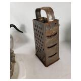 Vintage kitchenware including Glasbake and Tupperware dishes, ABCO aluminum pitcher, Vollrath stainless steel pitcher, and a metal grater with mold pan