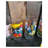 Lot of Disney and other drinking glasses of various styles
