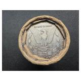 Unopened 20 coin roll of Morgan silver dollars with an 1893 at one end and a CC at the other end