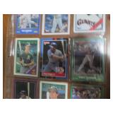 Double sided page of sports cards including Cal Ripken, Wade Boggs, Mark McGuire, Darryl Strawberry, Jose Canseco and others